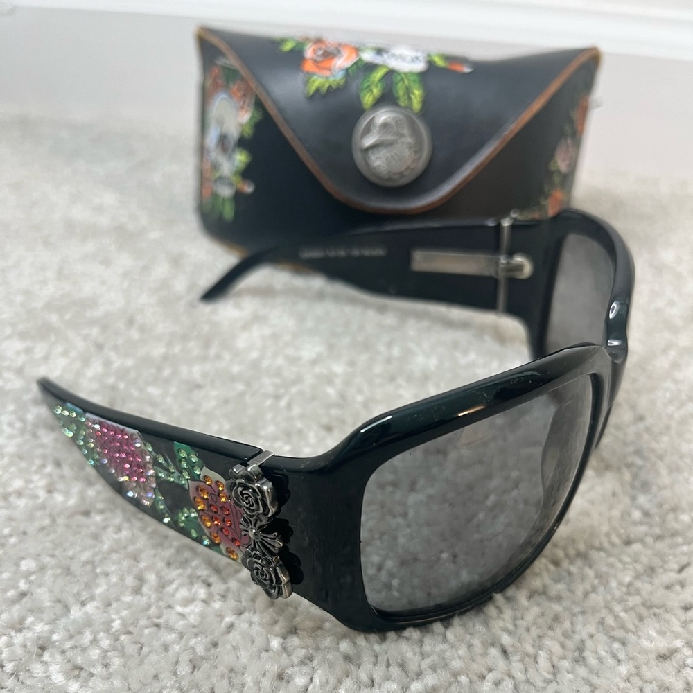 Ed Hardy sunglasses with tattoo artwork and rhinestones applied along both temple arms